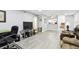 Living room with gray walls, wood-look floors, and office area at 2650 Countryside Blvd # C309, Clearwater, FL 33761