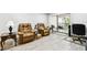 Living area with gray walls, wood-look floors, and comfortable armchairs at 2650 Countryside Blvd # C309, Clearwater, FL 33761
