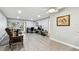 Living room with gray walls, wood-look floors, and access to balcony at 2650 Countryside Blvd # C309, Clearwater, FL 33761
