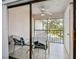 Screened balcony with outdoor furniture and nature view at 2650 Countryside Blvd # C309, Clearwater, FL 33761