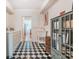 Bright laundry room with washer, dryer, and checkerboard floor at 2926 W Alline Ave, Tampa, FL 33611