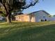 Side view of the house showcasing the landscaping and exterior at 3066 Kingston St, Port Charlotte, FL 33952