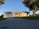 Charming ranch home with a white brick facade and mature trees at 3066 Kingston St, Port Charlotte, FL 33952