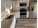 Modern kitchen with stainless steel appliances and granite countertops at 3066 Kingston St, Port Charlotte, FL 33952