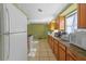 Galley kitchen with wood cabinets and white appliances at 4024 Grove S St, St Petersburg, FL 33705