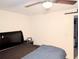 Bright bedroom with a double bed, ceiling fan, and ample wall space at 4214 Trucious Pl, New Port Richey, FL 34652
