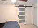Simple bedroom with a barn door, double bed, and ceiling fan at 4214 Trucious Pl, New Port Richey, FL 34652