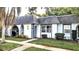 Charming light-grey exterior condo with well-maintained landscaping and walkway at 4214 Trucious Pl, New Port Richey, FL 34652