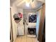 Convenient laundry area with stacked washer and dryer, and extra shelving at 4214 Trucious Pl, New Port Richey, FL 34652