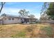 Large backyard featuring a screened patio and solar panels at 4235 Chipmunk Dr, New Port Richey, FL 34653