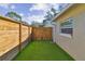 Artificial turf backyard with wood fence and gate at 4320 63Rd N St, Kenneth City, FL 33709