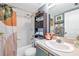 Clean bathroom with a tub, shower, and storage cabinet at 5567 Sea Forest Dr # 320, New Port Richey, FL 34652