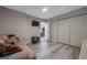 Spacious bedroom with a sofa, TV, and large closet at 5567 Sea Forest Dr # 320, New Port Richey, FL 34652