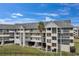 Exterior view of condo building with parking and landscaping at 5567 Sea Forest Dr # 320, New Port Richey, FL 34652