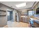 Galley kitchen with stainless steel appliances and gray cabinets at 5567 Sea Forest Dr # 320, New Port Richey, FL 34652