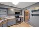 L-shaped kitchen with stainless steel appliances and gray cabinets at 5567 Sea Forest Dr # 320, New Port Richey, FL 34652