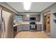 Gray kitchen cabinets, stainless steel appliances, and view to dining area at 5567 Sea Forest Dr # 320, New Port Richey, FL 34652