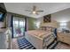 Spacious main bedroom with a king bed and access to a balcony at 5567 Sea Forest Dr # 320, New Port Richey, FL 34652