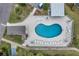 Community pool with ample lounge chairs and shaded area at 5567 Sea Forest Dr # 320, New Port Richey, FL 34652