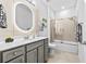 Modern bathroom with a tub, shower, and gray vanity at 5672 Bay Tide Ct, Land O Lakes, FL 34638