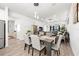 Open dining room with a wood table and view to living room at 5672 Bay Tide Ct, Land O Lakes, FL 34638
