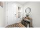 Bright entryway with wood floors, console table, and mirror at 5672 Bay Tide Ct, Land O Lakes, FL 34638