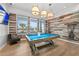 Game room with pool table, comfortable seating, and wood walls at 5672 Bay Tide Ct, Land O Lakes, FL 34638
