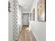 Long hallway showcasing stylish wall art and wood flooring at 5672 Bay Tide Ct, Land O Lakes, FL 34638