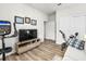 Home gym with stationary bike, treadmill, and flat screen TV at 5672 Bay Tide Ct, Land O Lakes, FL 34638