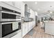 Bright kitchen featuring double ovens and white cabinets at 5672 Bay Tide Ct, Land O Lakes, FL 34638