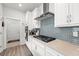 Modern kitchen with stainless steel appliances and grey tile backsplash at 5672 Bay Tide Ct, Land O Lakes, FL 34638