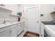 Laundry room with washer, dryer, cabinets, and utility sink at 5672 Bay Tide Ct, Land O Lakes, FL 34638