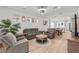 Open living room with hardwood floors and grey couches at 5672 Bay Tide Ct, Land O Lakes, FL 34638