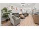 Open living room with hardwood floors and grey couches at 5672 Bay Tide Ct, Land O Lakes, FL 34638