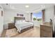 Bright main bedroom with large window and wood flooring at 5672 Bay Tide Ct, Land O Lakes, FL 34638