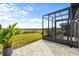 Screened-in patio with seating and a view of the backyard at 5672 Bay Tide Ct, Land O Lakes, FL 34638