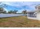 Backyard view showcasing a large grassy area and a white vinyl fence at 5912 32Nd N Ave, St Petersburg, FL 33710