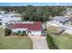 Single-story home with red tile roof, driveway, and fenced backyard at 6004 1St W Ave, Bradenton, FL 34209