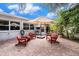 Relaxing patio with red chairs and a patio umbrella at 6004 1St W Ave, Bradenton, FL 34209