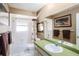 Bathroom with a tub shower combo and green vanity at 6004 1St W Ave, Bradenton, FL 34209