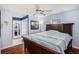 Main bedroom with en-suite bathroom, ceiling fan, and large bed at 6004 1St W Ave, Bradenton, FL 34209