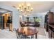 Bright dining room with a round wooden table and chandelier at 6004 1St W Ave, Bradenton, FL 34209