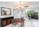 Open dining area with round table, kitchen view, and access to screened porch at 6004 1St W Ave, Bradenton, FL 34209