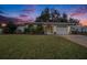 Charming ranch home with well-manicured lawn and a white garage door at 6004 1St W Ave, Bradenton, FL 34209