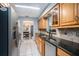 Efficient kitchen with oak cabinets, granite countertops, and stainless steel appliances at 6004 1St W Ave, Bradenton, FL 34209