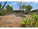 Spacious backyard with gravel landscaping and tropical plants at 6208 Spanish Main Dr, Apollo Beach, FL 33572