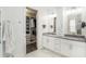 Double vanity bathroom with gray countertops and walk-in closet at 6408 Key Island Ave, Apollo Beach, FL 33572