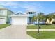 Beautiful two-story home with a white garage door and lush landscaping at 6408 Key Island Ave, Apollo Beach, FL 33572