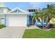 Coastal style home with a white garage door and nicely landscaped yard at 6408 Key Island Ave, Apollo Beach, FL 33572