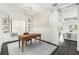 Bright home office with wood desk, built-in shelves, and sliding barn door at 6408 Key Island Ave, Apollo Beach, FL 33572